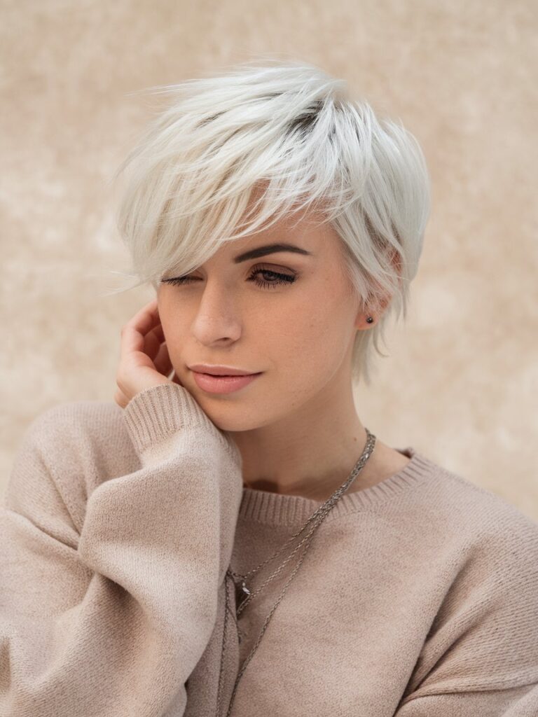 18. Platinum Blonde Pixie with Side-Swept Bangs