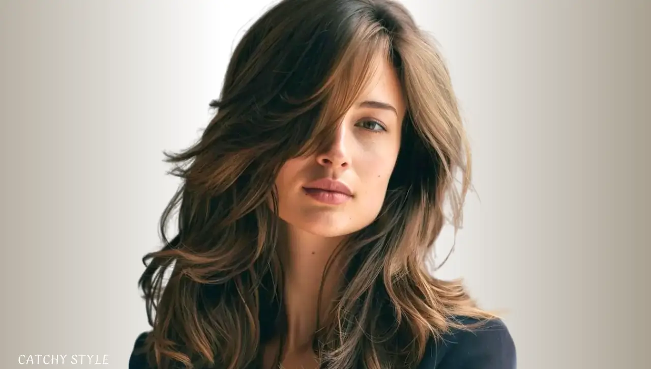 Butterfly haircut with side-swept bangs for a soft and subtle finish